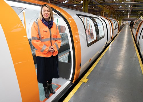 Transport Minister standing inside new Subway train